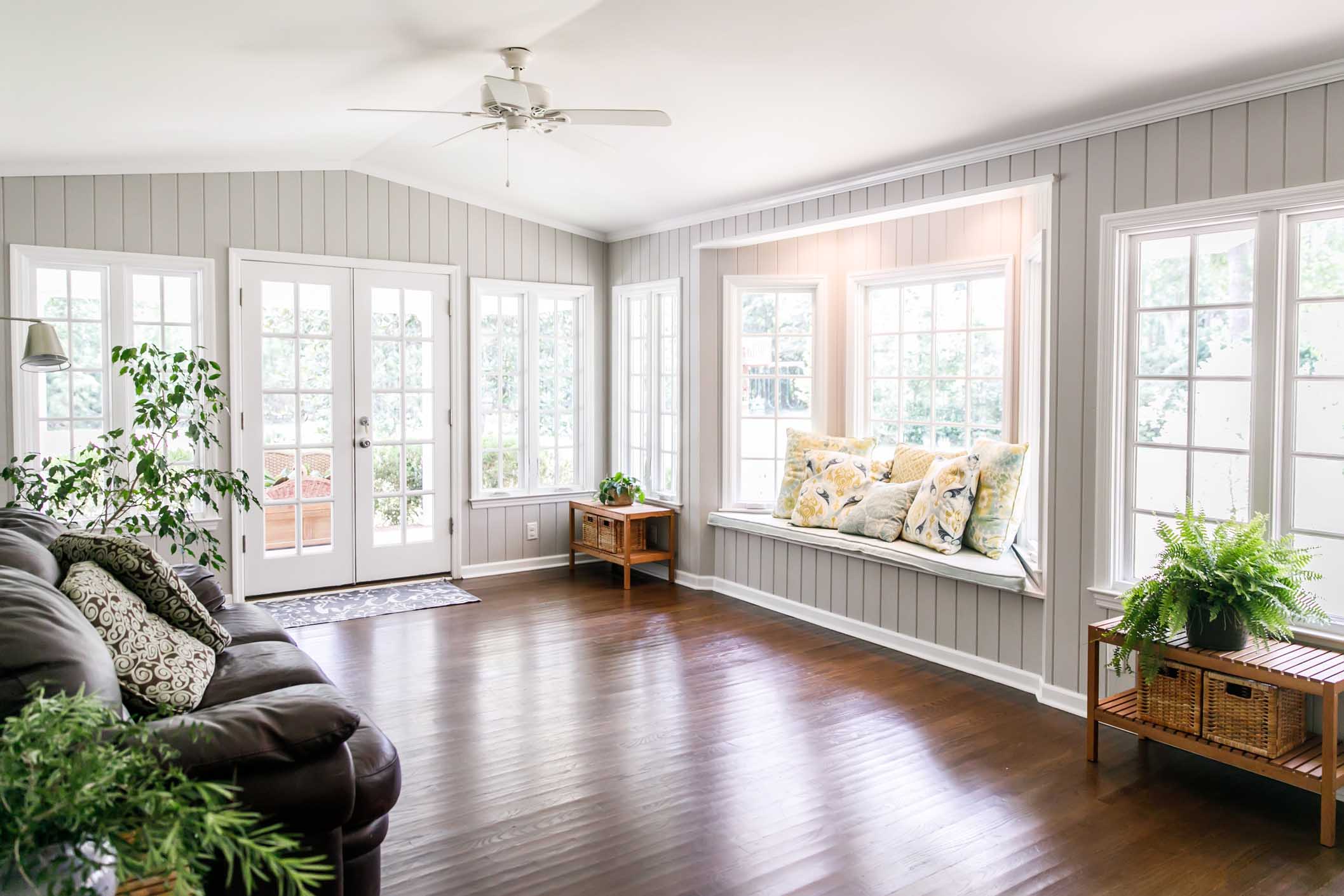 Large and open living room den sun room with windows on two sides